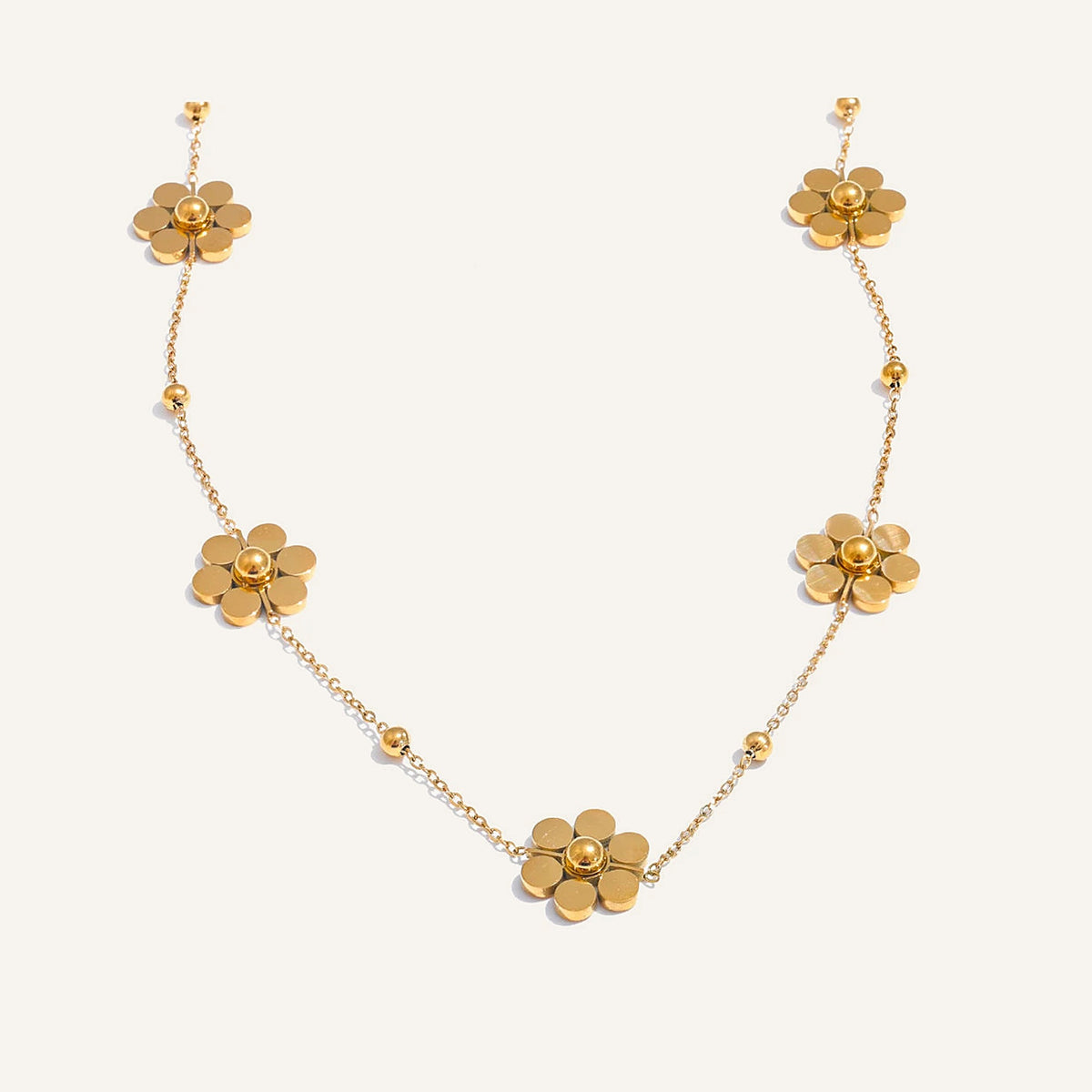 Collier avec petites fleurs, doré, sur fond clair – Charmhabit