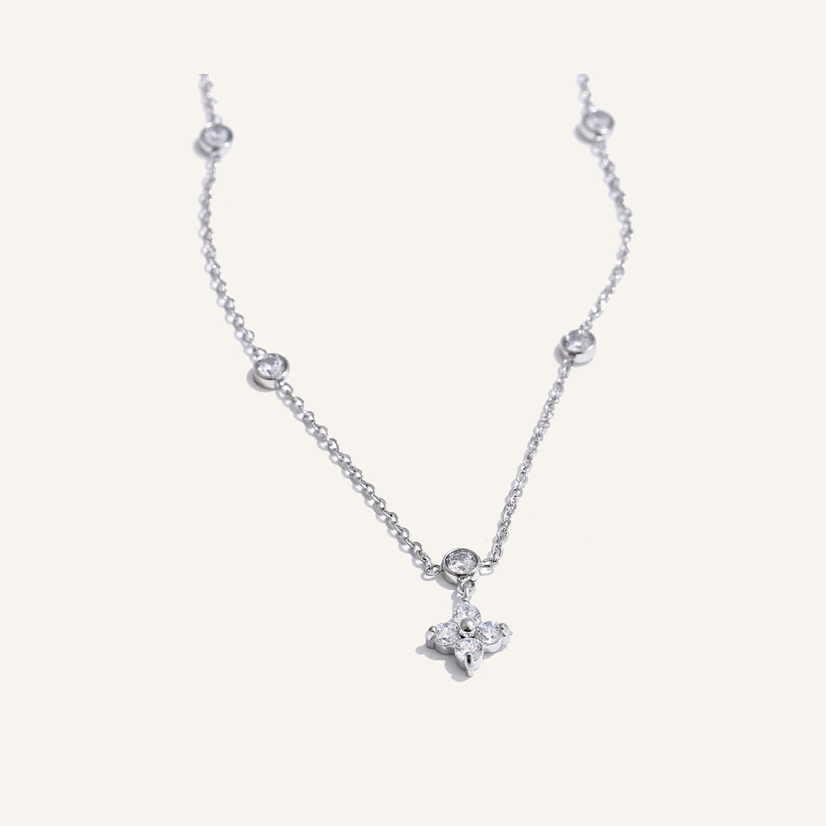 Necklace with cubic zirconia flower pendant, silver tone, on a light background – Charmhabit