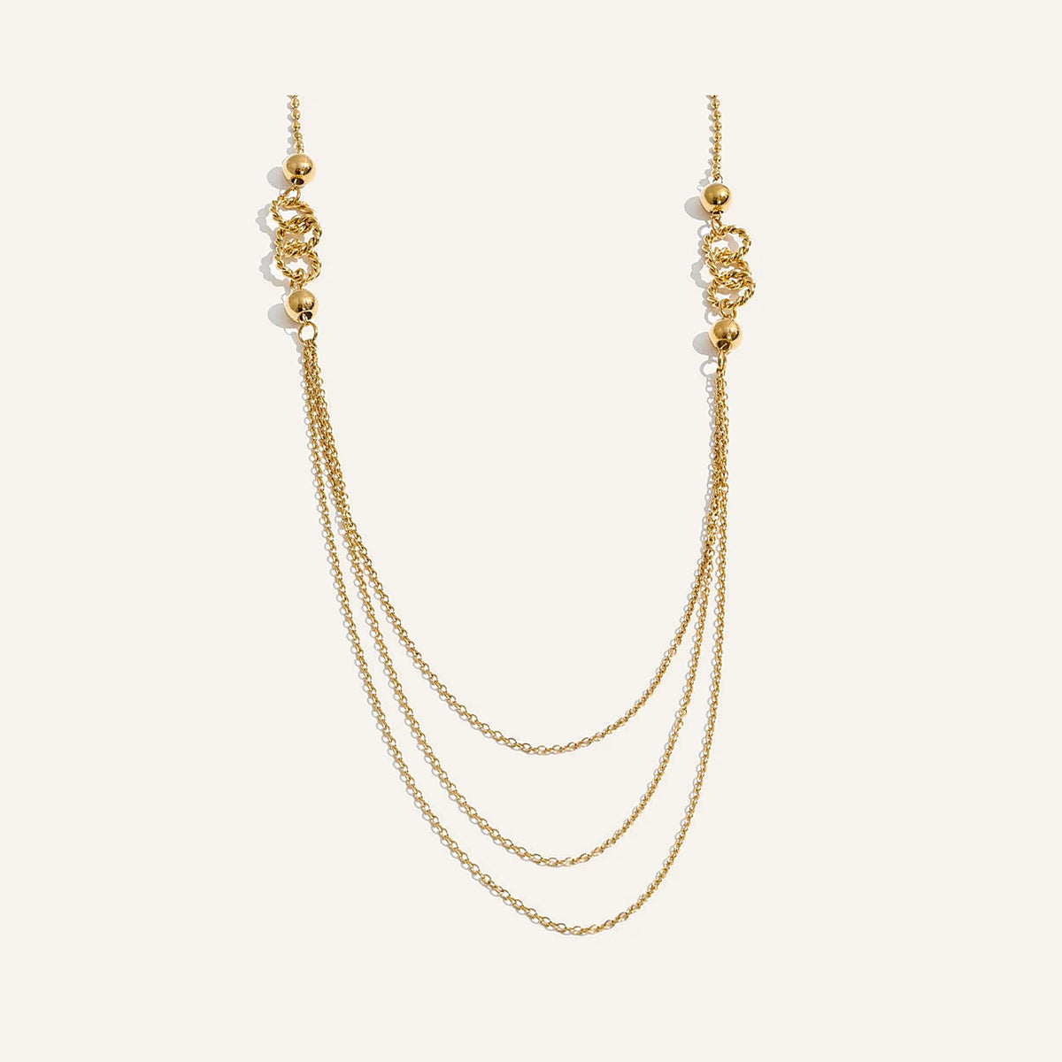 Long layered necklace, gold tone, on a light background – Charmhabit