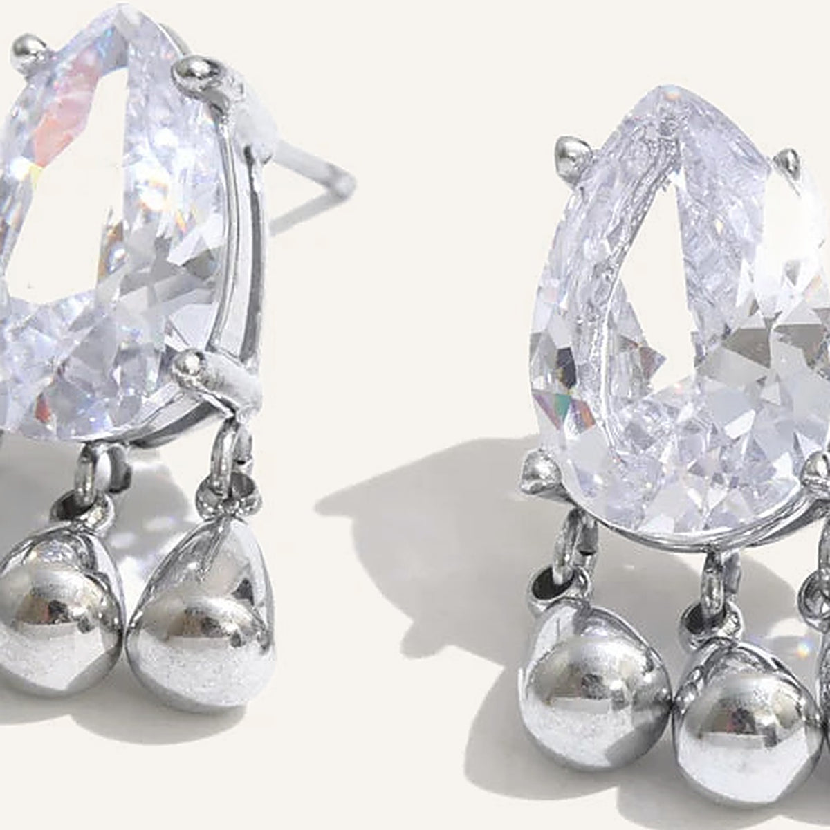 Cubic zirconia drop stud earrings with charms, silver tone, close-up – Charmhabit