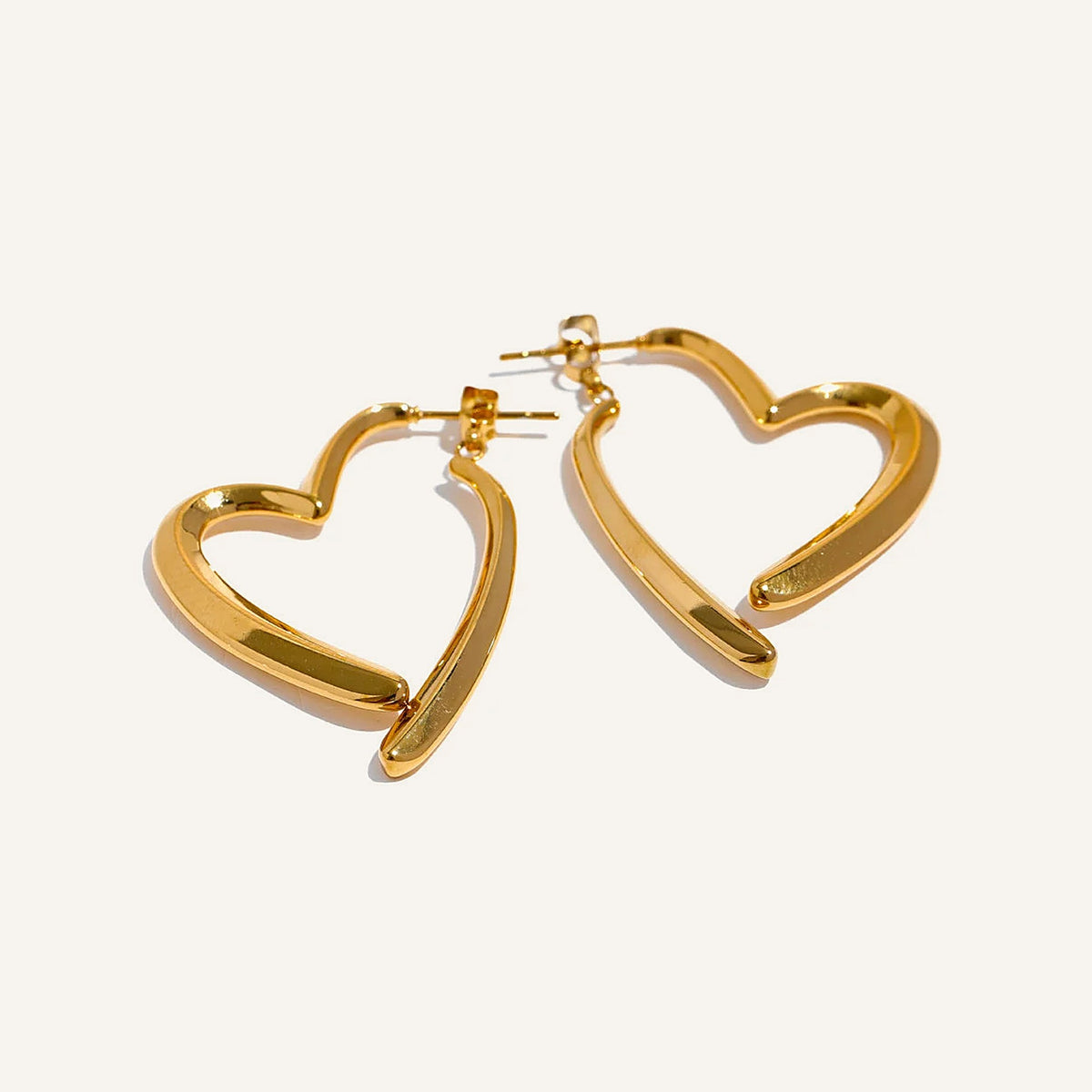 Open heart-shaped earrings with a high-gloss finish, gold tone, on a light background – Charmhabit