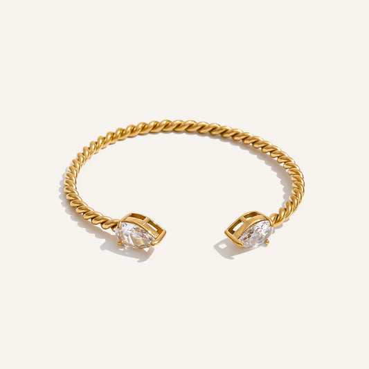 Open cuff bracelet with cubic zirconia, gold tone, on a light background – Charmhabit