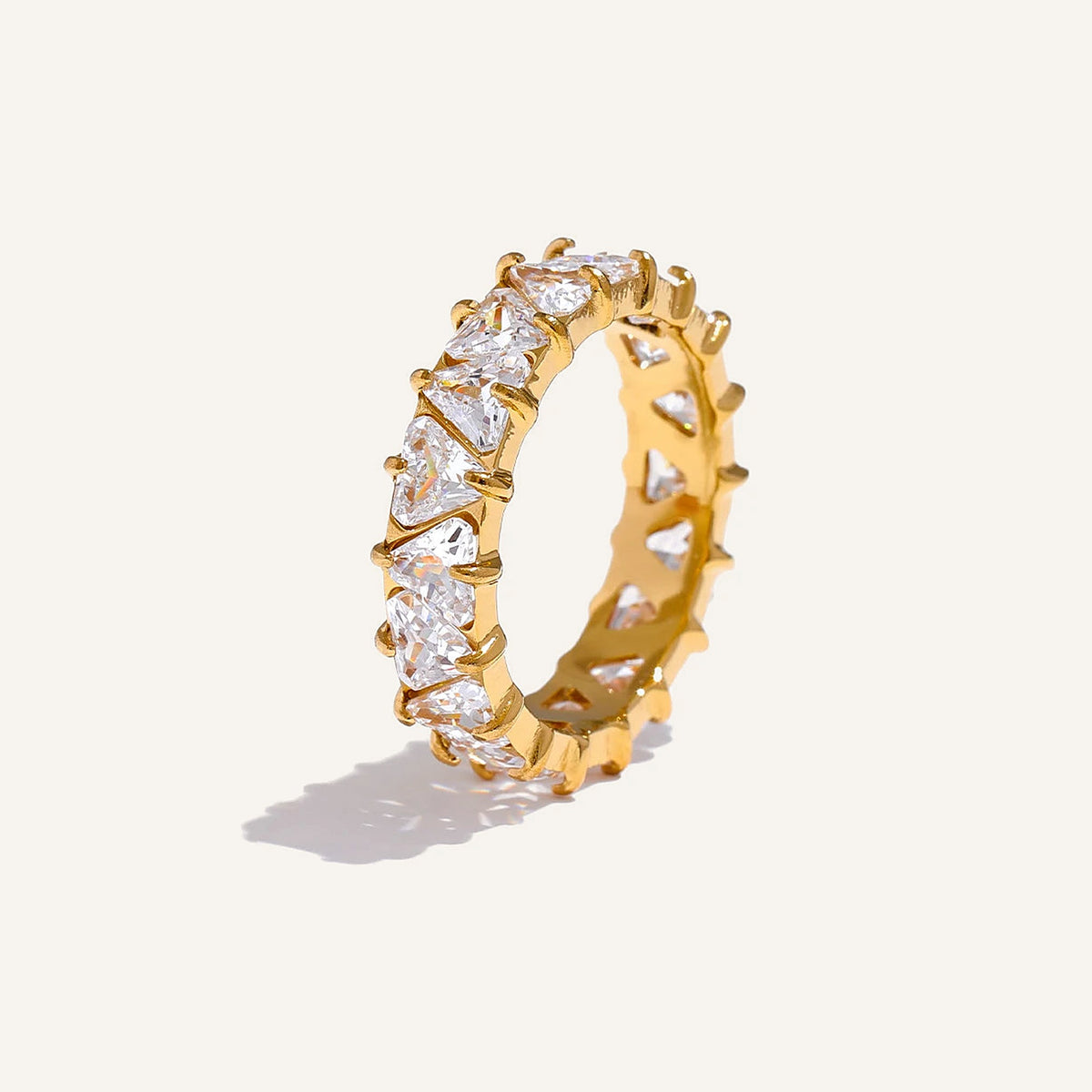 Ring with cubic zirconia hearts, gold tone, on a light background – Charmhabit