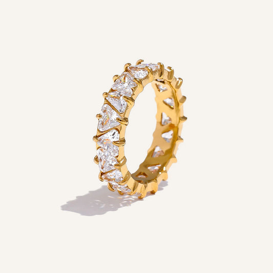 Ring with cubic zirconia hearts, gold tone, on a light background – Charmhabit