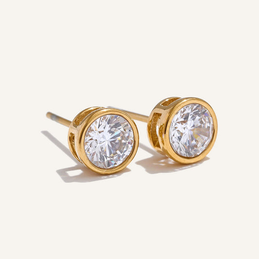 Round cubic zirconia stud earrings, gold tone, on a light background – Charmhabit