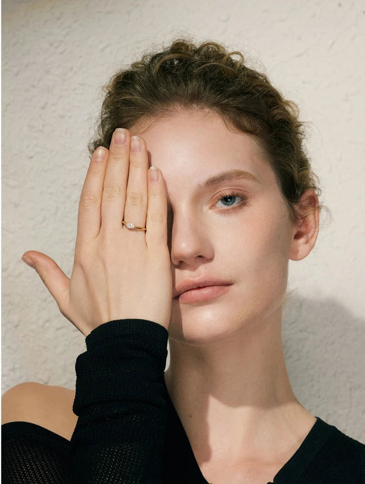 Marquise-cut cubic zirconia solitaire ring, worn on the hand in front of the face – Charmhabit