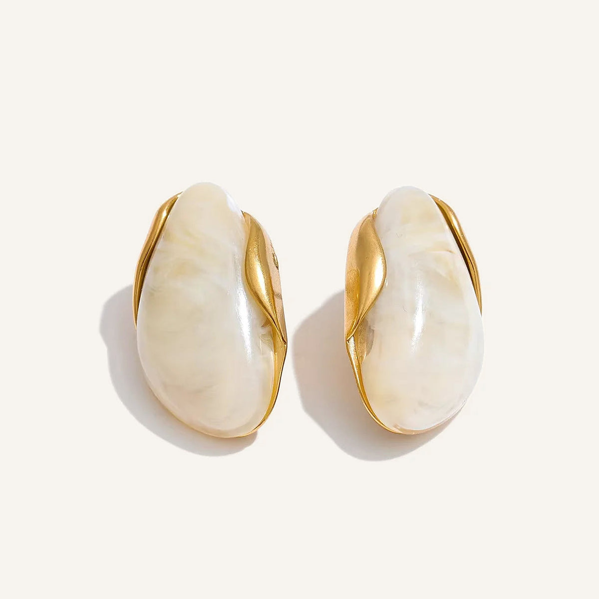 Statement resin stud earrings in beige on a light background – Charmhabit