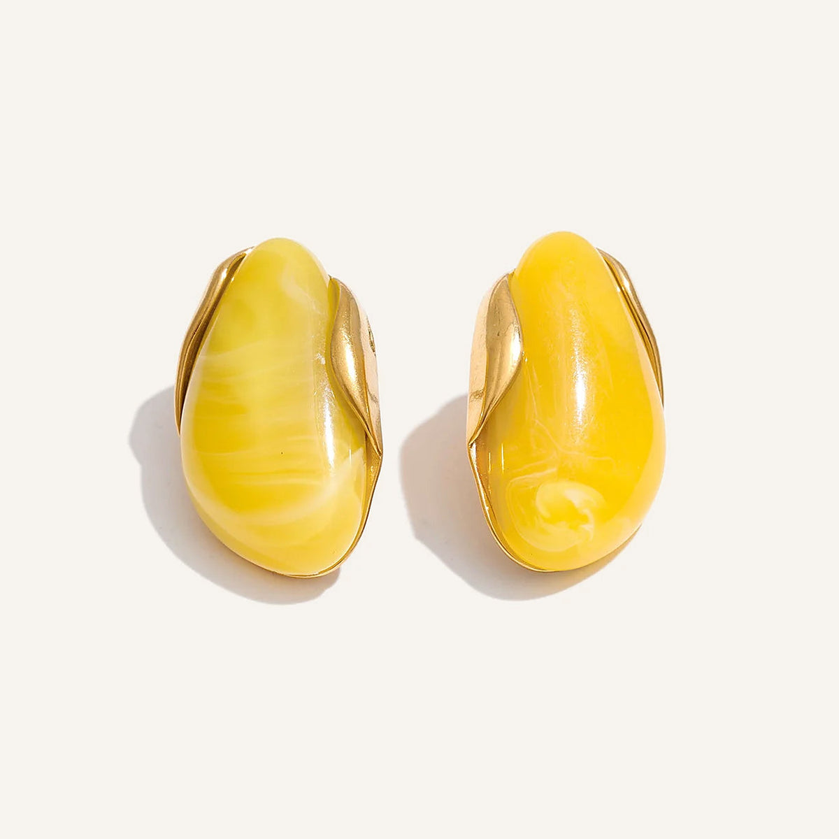 Statement resin stud earrings in yellow on a light background – Charmhabit