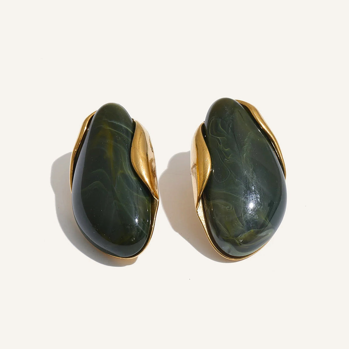 Statement resin stud earrings in dark green on a light background – Charmhabit