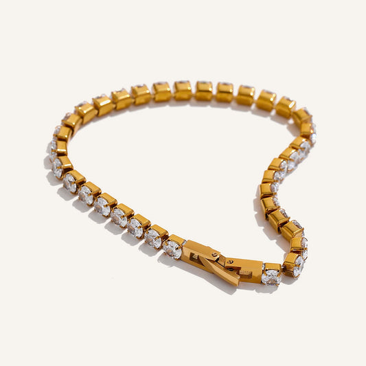 Tennis bracelet with cubic zirconia, gold tone, on a light background – Charmhabit