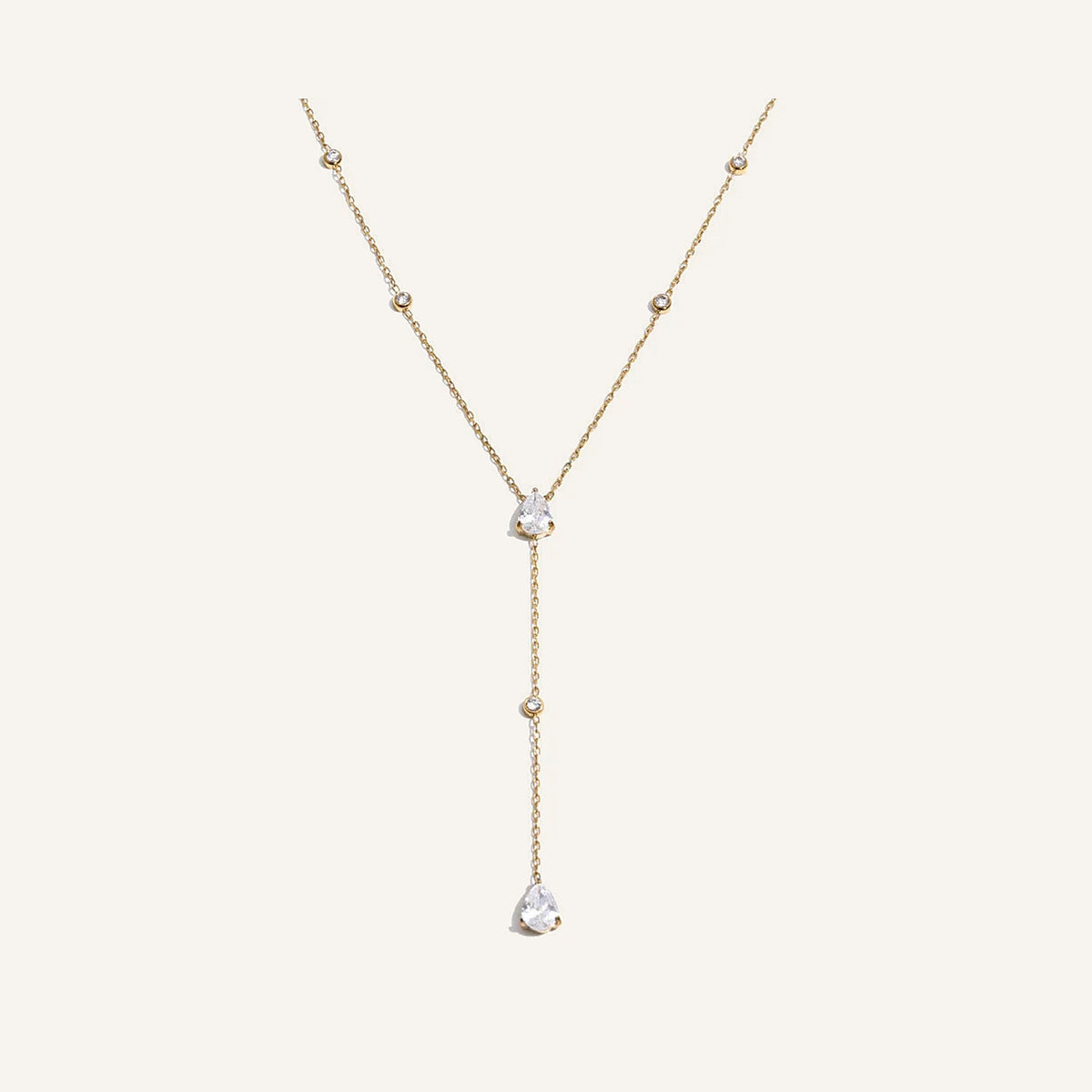 Y-necklace with drop pendant, gold tone, on a light background – Charmhabit
