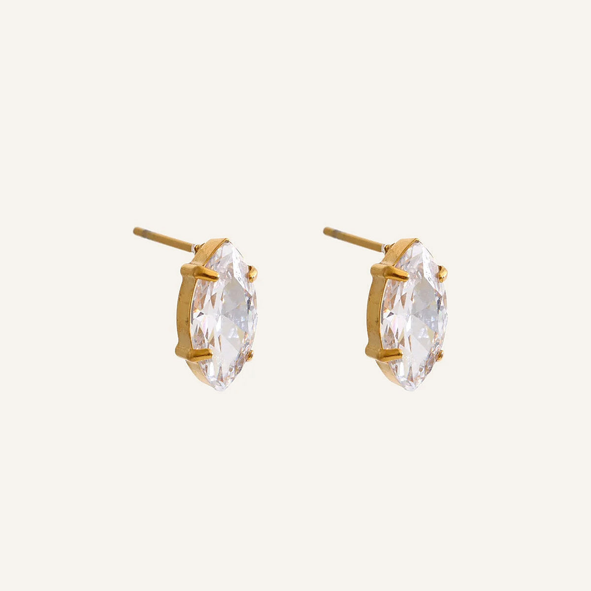Zirkonia-Ohrstecker in Marquiseform mit Krappenfassung, goldfarben, auf hellem Hintergrund – Charmhabit