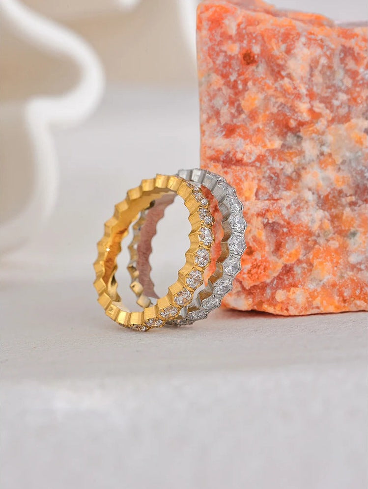 Cubic zirconia ring with hexagonal setting in gold and silver tones, styled shot on stone – Charmhabit