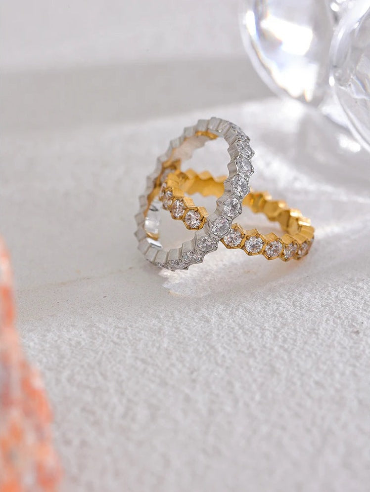 Cubic zirconia ring with hexagonal setting, gold and silver tones, close-up – Charmhabit