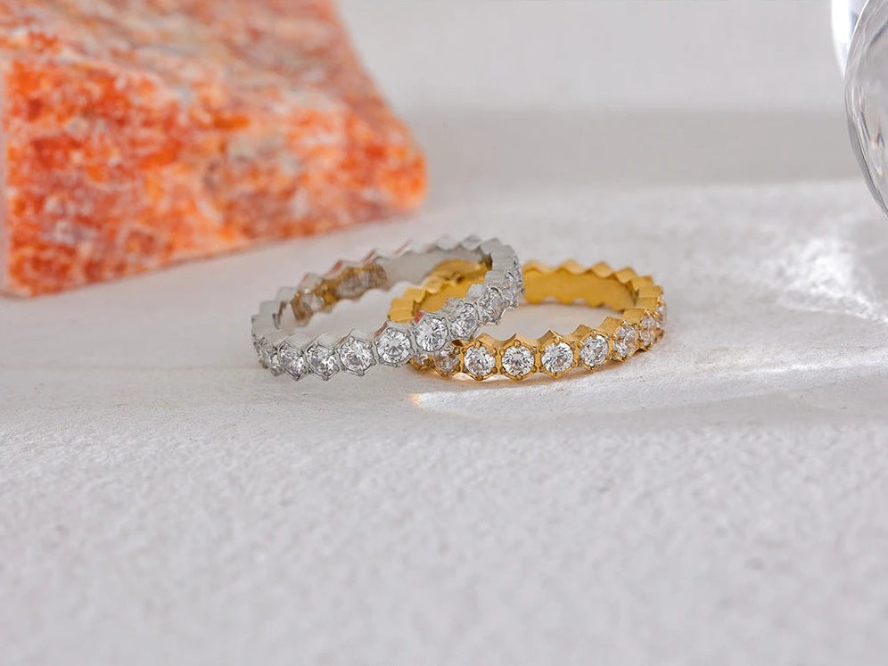 Cubic zirconia ring with hexagonal setting, gold and silver tones, on a light background – Charmhabit