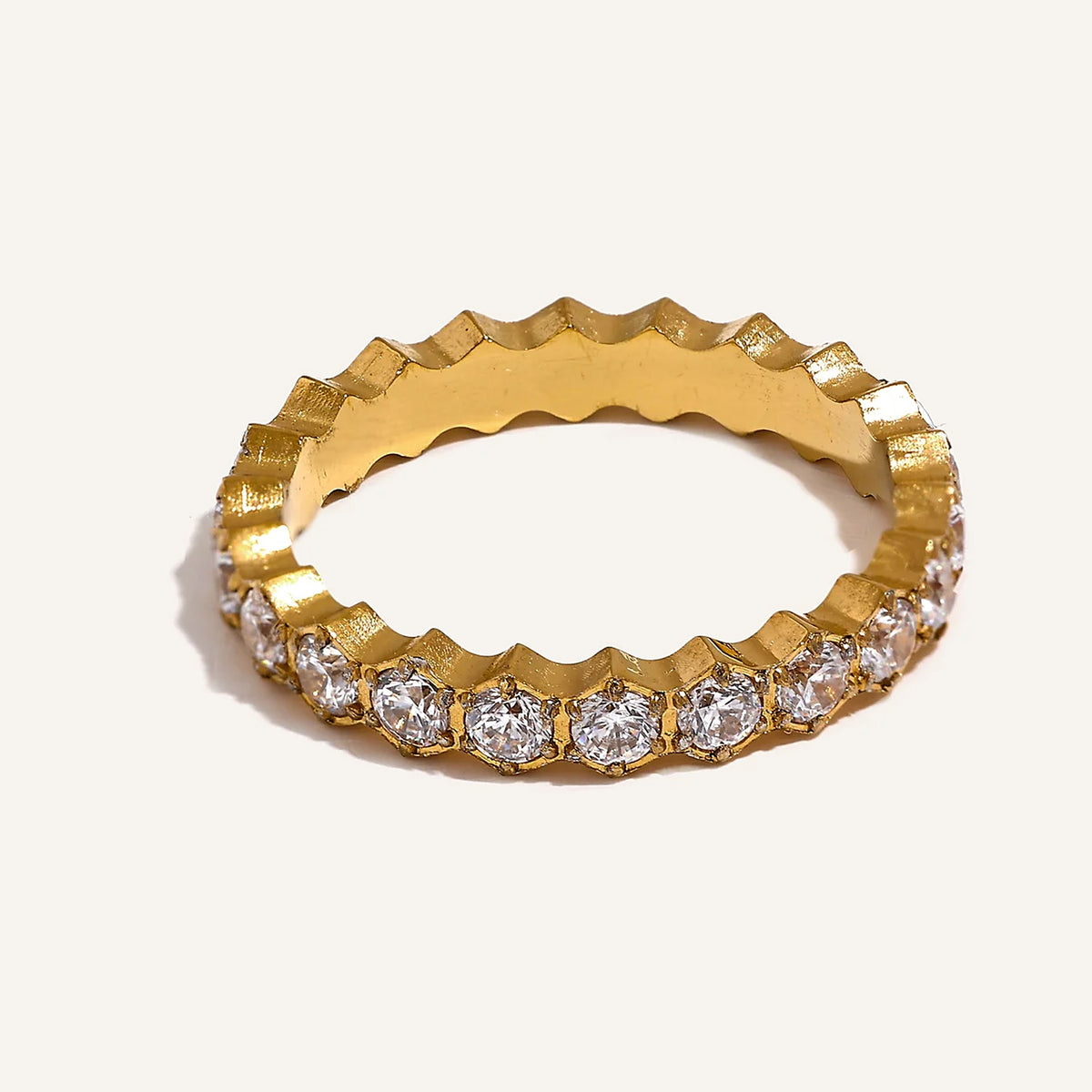 Cubic zirconia ring with hexagonal setting, gold tone, on a light background – Charmhabit