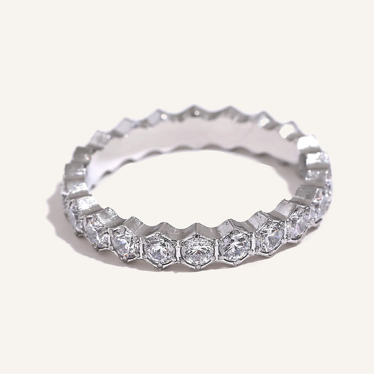 Cubic zirconia ring with hexagonal setting, silver tone, on a light background – Charmhabit